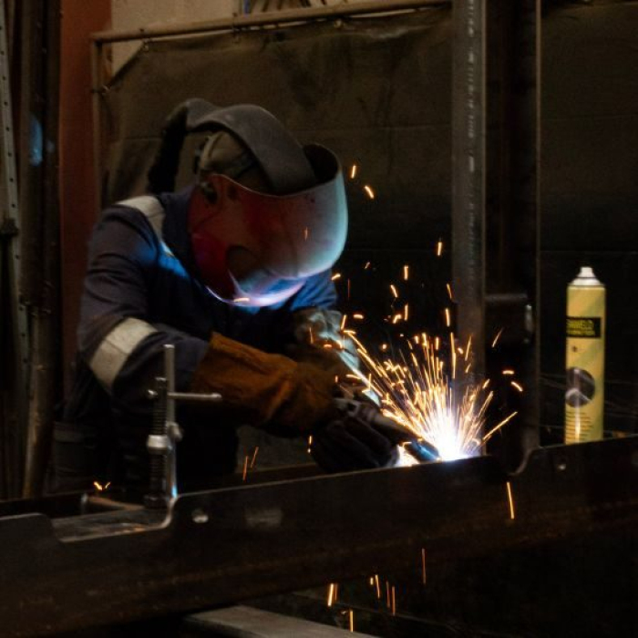 Welder at DMAC Engineering welding with BEAM on torch extraction system
